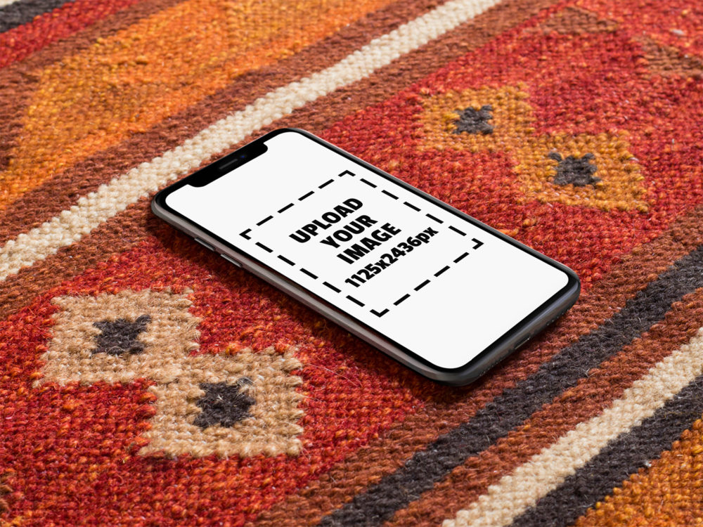 iPhone X Mockup Lying on a Red Carpet by Placeit