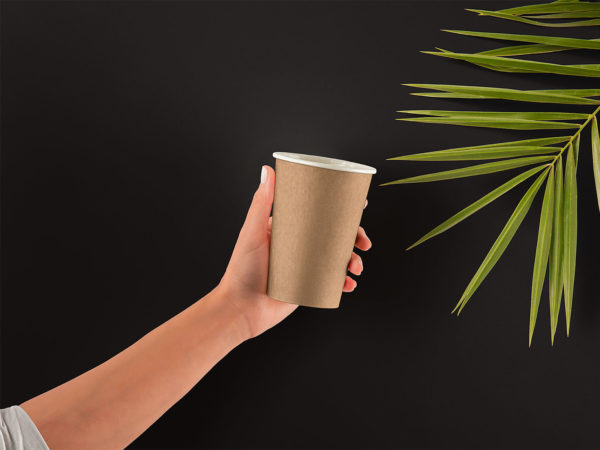 Hand holding paper cup mockup