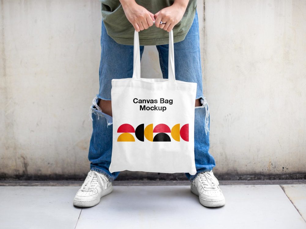 Man holding tote bag mockup