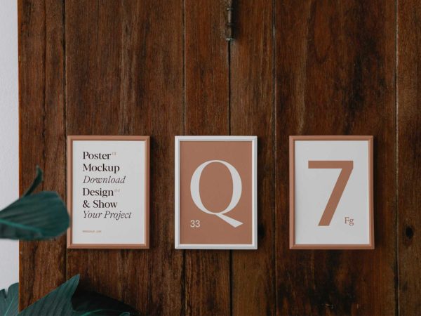 Three Poster Frame Mockups on Wood Wall