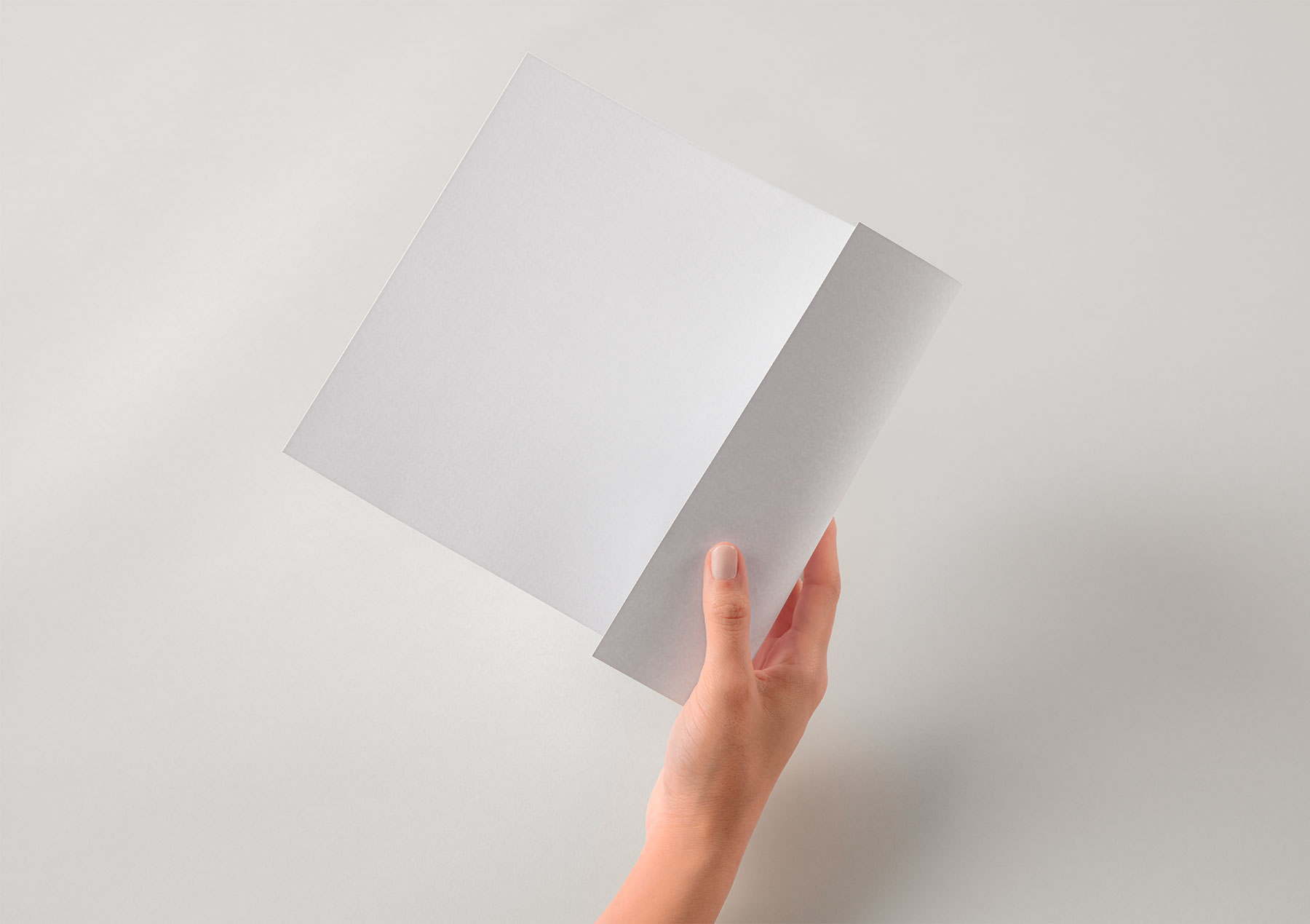 Hand Holding Brand Paper Mockup